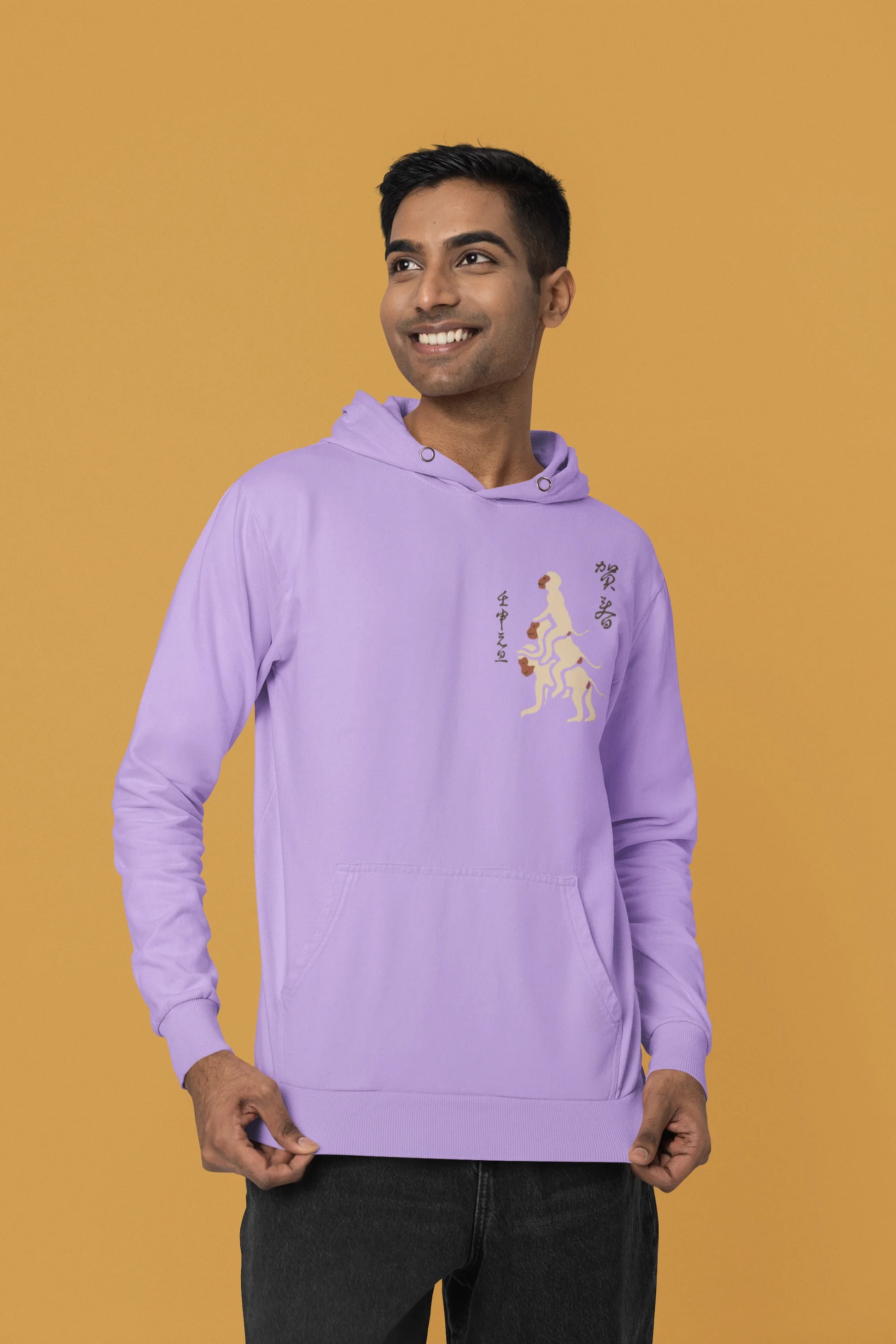First front view of a male model wearing a lavender hoodie with a design of the three wise monkeys: "See no evil, hear no evil, speak no evil."