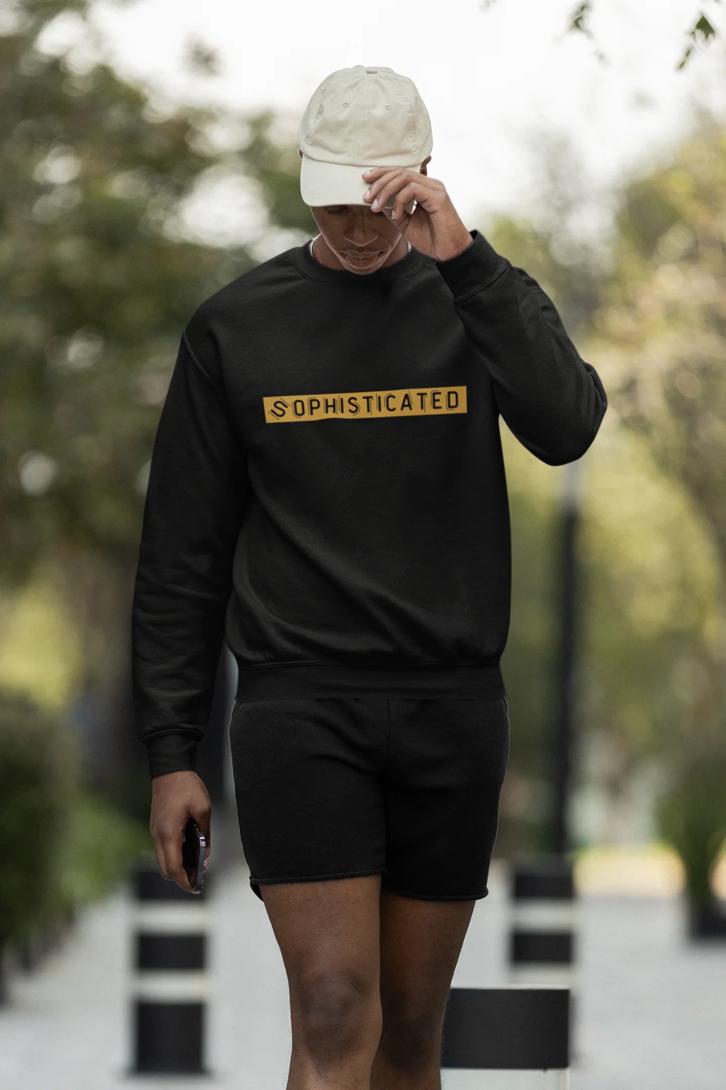 Third front view of a male model wearing a black sweatshirt with a sophisticated brutalist design featuring a Greek god statue.