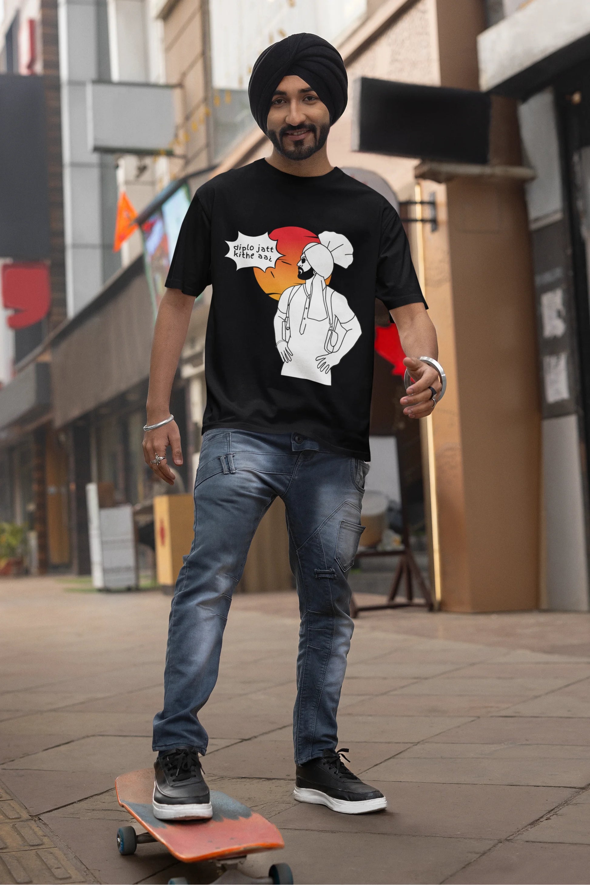 Second image of a male model wearing a black oversized tshirt with a A portrait of Diljit Dosanjh wearing a stylish outfit, with the text "Diplo Jatt Kithe Aai" prominently displayed in the background. The design captures the artist's charisma and the energy of the hit song, making it a must-have for fans of Diljit Dosanjh and Diplo alike. 