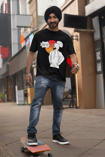 Second image of a male model wearing a black oversized tshirt with a A portrait of Diljit Dosanjh wearing a stylish outfit, with the text "Diplo Jatt Kithe Aai" prominently displayed in the background. The design captures the artist's charisma and the energy of the hit song, making it a must-have for fans of Diljit Dosanjh and Diplo alike. 