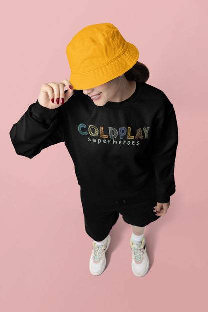 Second front view of a female model wearing an black sweatshirt with a design inspired by the "Something Just Like This" music video, featuring the word "Superheroes".
