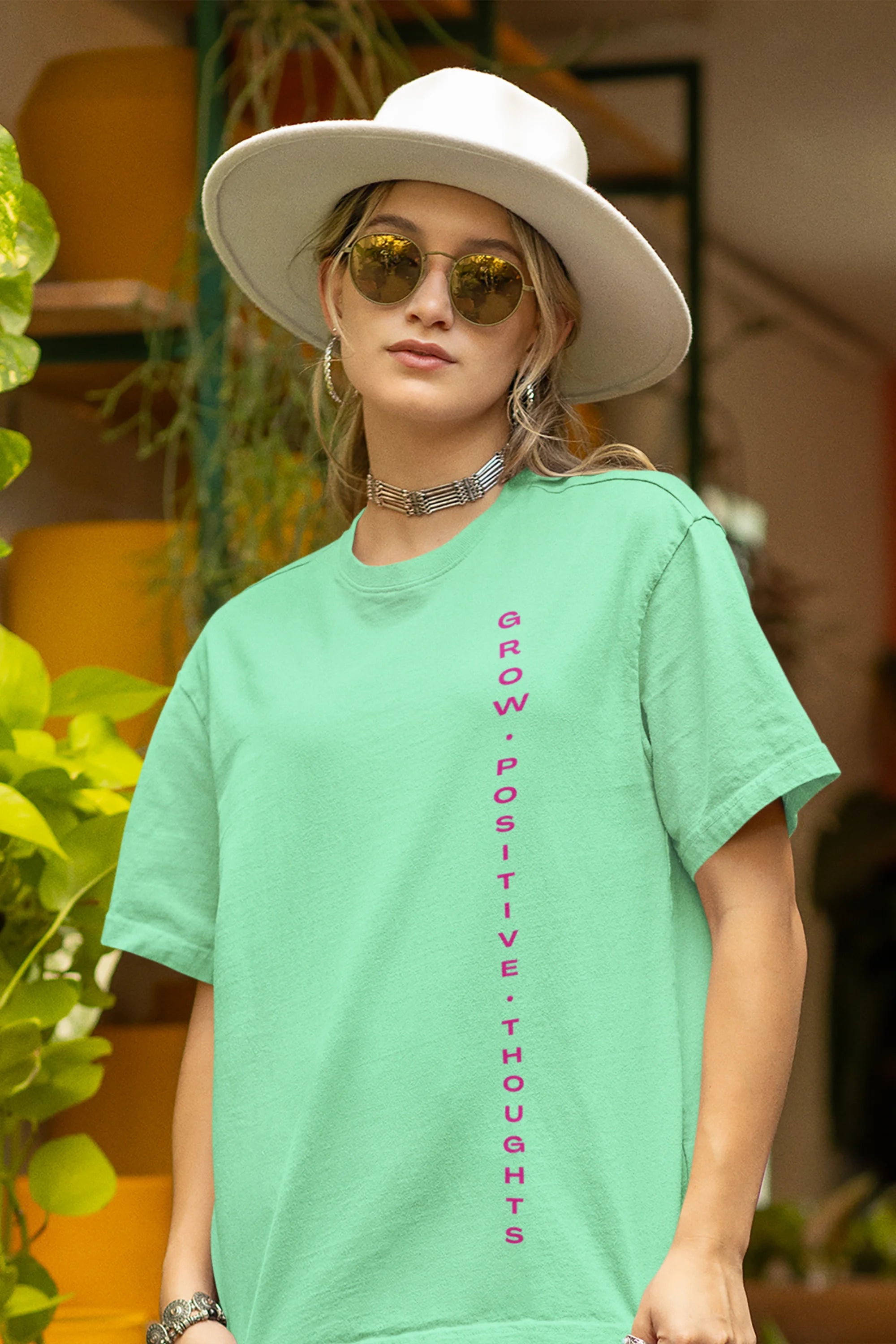 Front view of a female model wearing an mint green oversized t-shirt featuring a thought-provoking design of a man's bust with the text "Think It's Free of Cost." Ideal for those who love funny clothing and the importance of mindful communication.