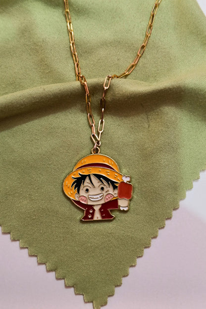2nd view of a gold chain necklace with a small pendant depicting Luffy from One Piece eating meat.