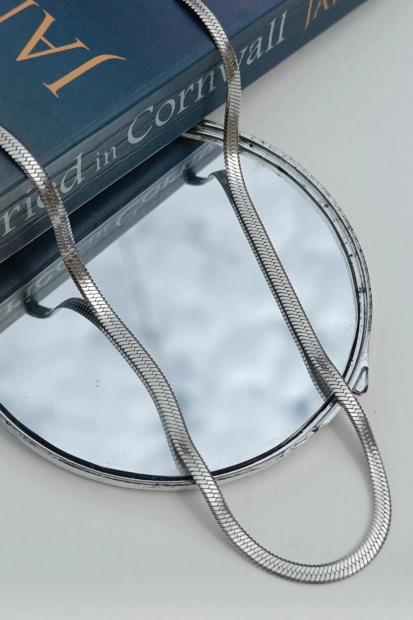 Third image of an anti tarnish silver chain necklace featuring a snake like design.