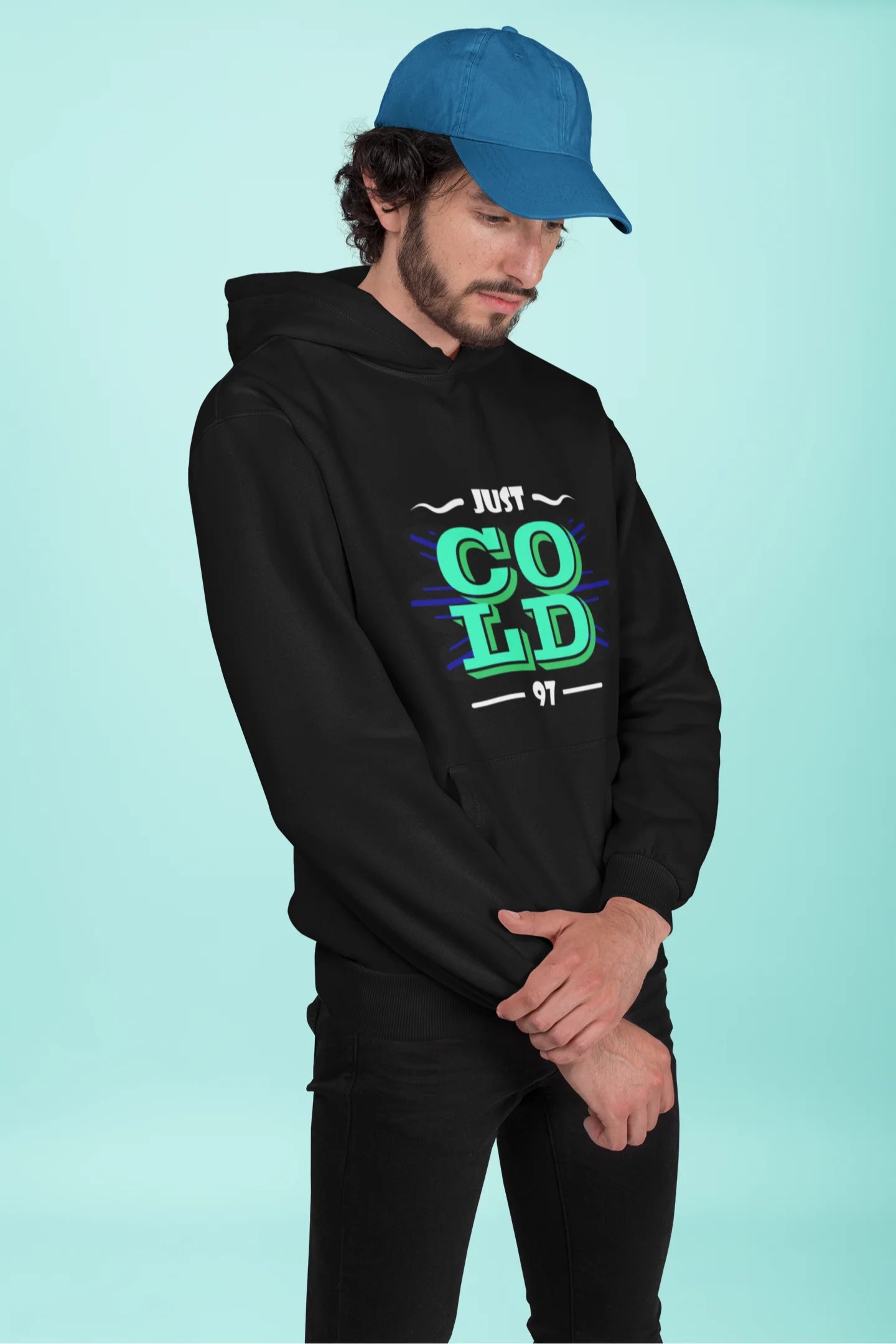 2nd front view of a male model wearing an black sweatshirt with the text "Just Cold" printed on it.