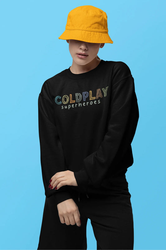 First front view of a female model wearing an black sweatshirt with a design inspired by the "Something Just Like This" music video, featuring the word "Superheroes".