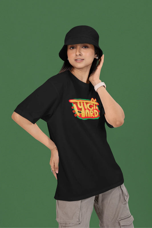 First front view of a female model wearing a black oversized t-shirt with the phrase "Party Hard" in an energetic Hindi.