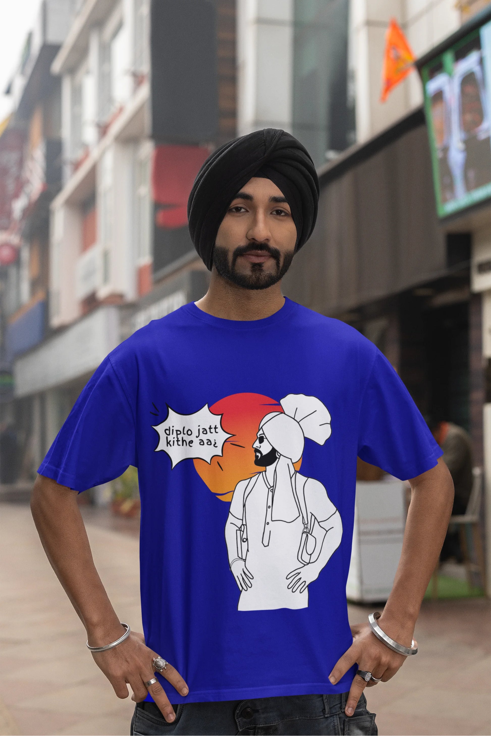 Third image of a male model wearing a royal blue oversized tshirt with a A portrait of Diljit Dosanjh wearing a stylish outfit, with the text "Diplo Jatt Kithe Aai" prominently displayed in the background. The design captures the artist's charisma and the energy of the hit song, making it a must-have for fans of Diljit Dosanjh and Diplo alike. 