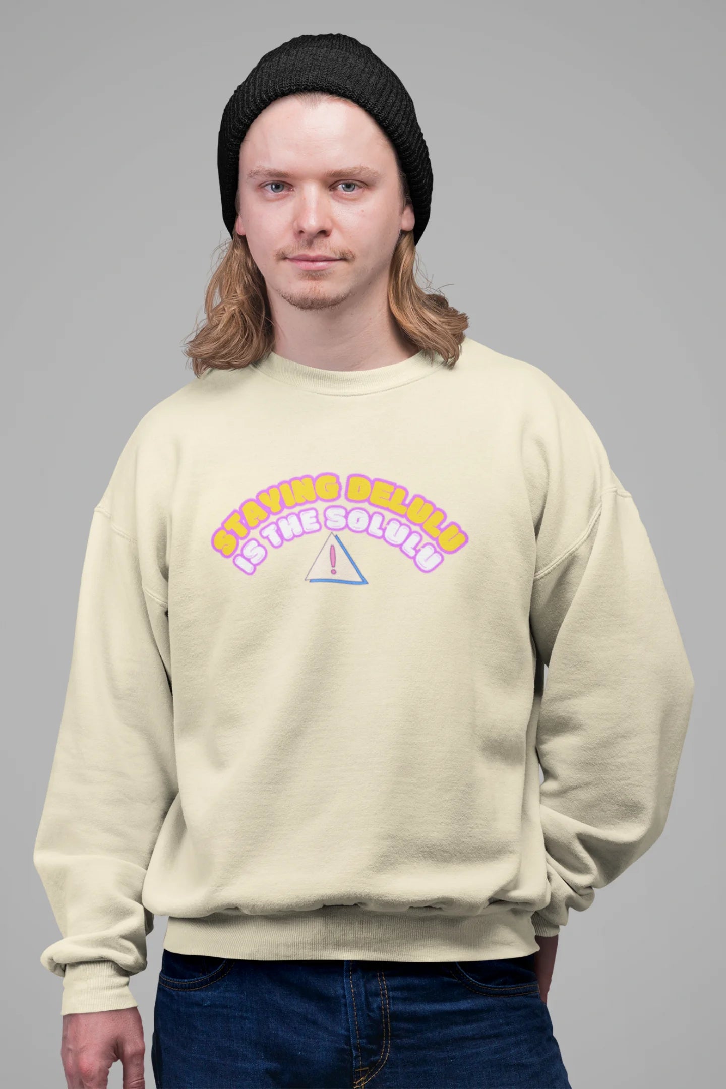 3rd front view of male model wearing a cream sweatshirt with the hilarious message "Stay Delulu" in a bold design. Ideal for those who love trendy slang and lighthearted humor.