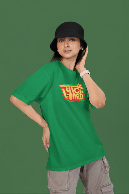 3rd front view of a female model wearing a forest green oversized t-shirt with the phrase "Party Hard" in an energetic Hindi.