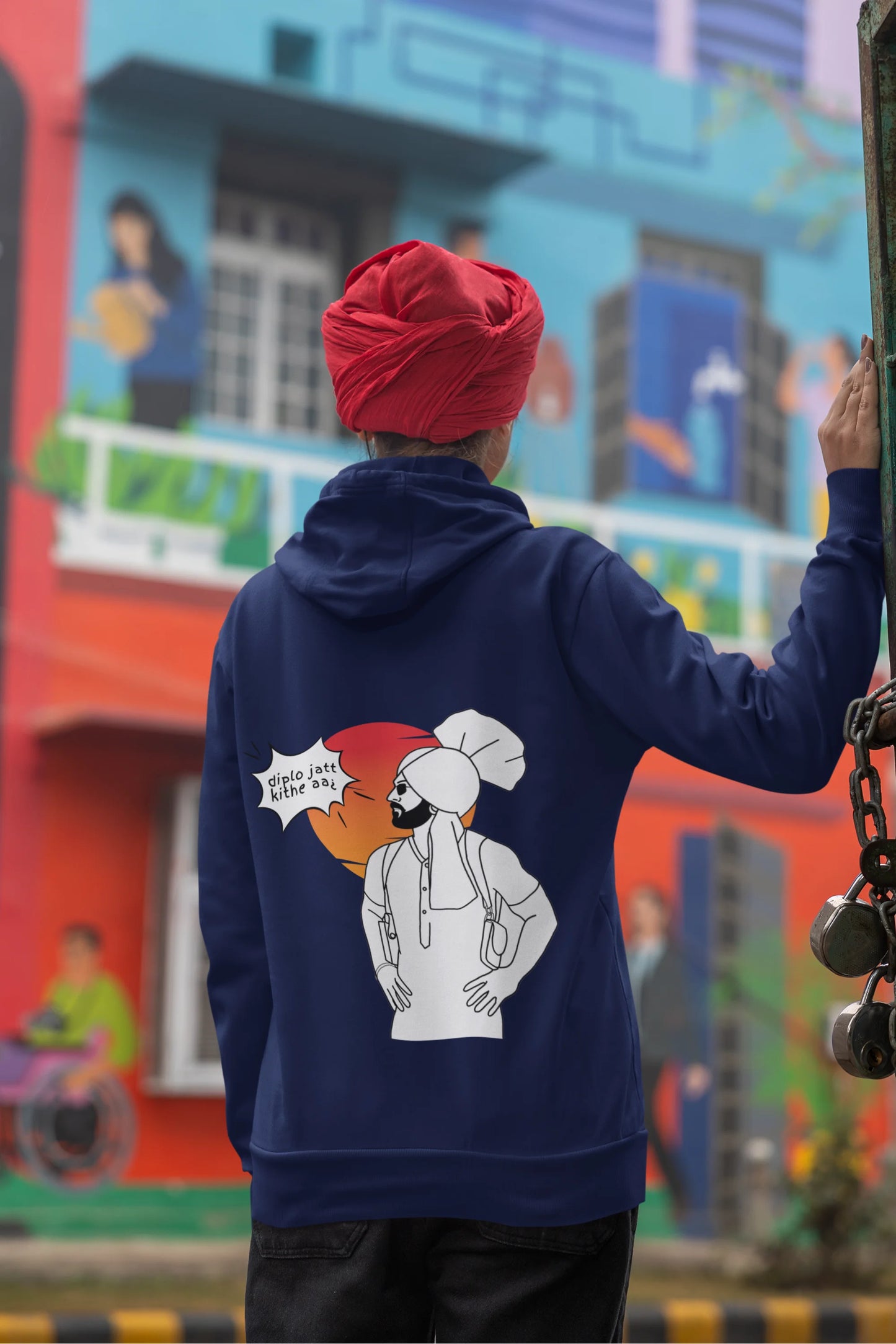 Back view of a female model wearing a royal blue hoodie with the text "Diplo Jatt Kithe Aai" and a vibrant design.