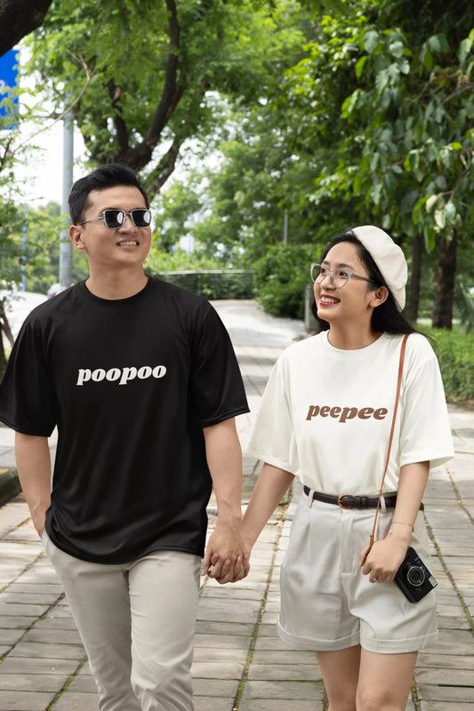 2nd front view of a couple wearing matching black and white oversize tees, one with the word "PeePee" and the other with the word "PooPoo".