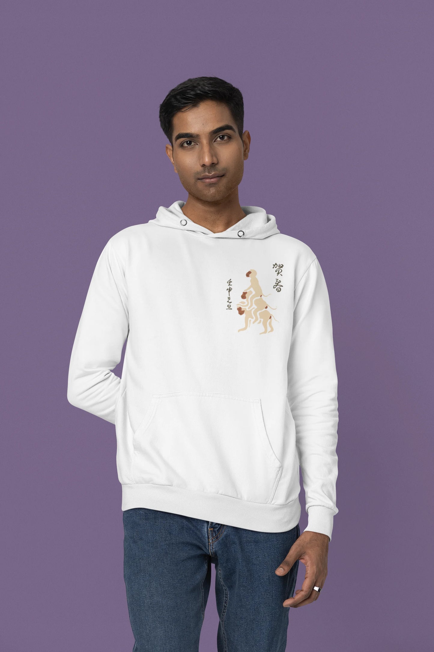 Fourth front view of a male model wearing a white hoodie with a design of the three wise monkeys: "See no evil, hear no evil, speak no evil."