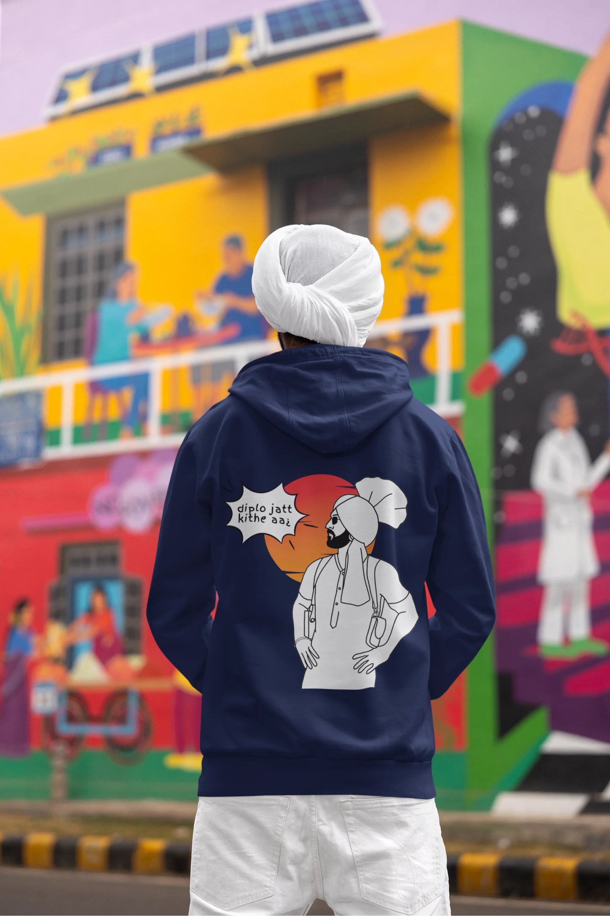 Back view of a male model wearing a royal blue hoodie with the text "Diplo Jatt Kithe Aai" and a vibrant design.