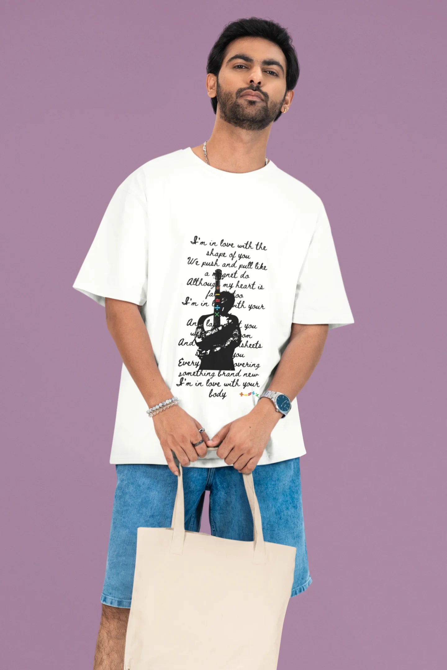 2nd front view of a male model wearing a off-white oversized t-shirt featuring a design inspired by Ed Sheeran's concerts, related to the song "Shape of You."