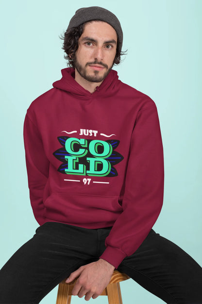 2nd front view of a male model wearing an maroon sweatshirt with the text "Just Cold" printed on it.