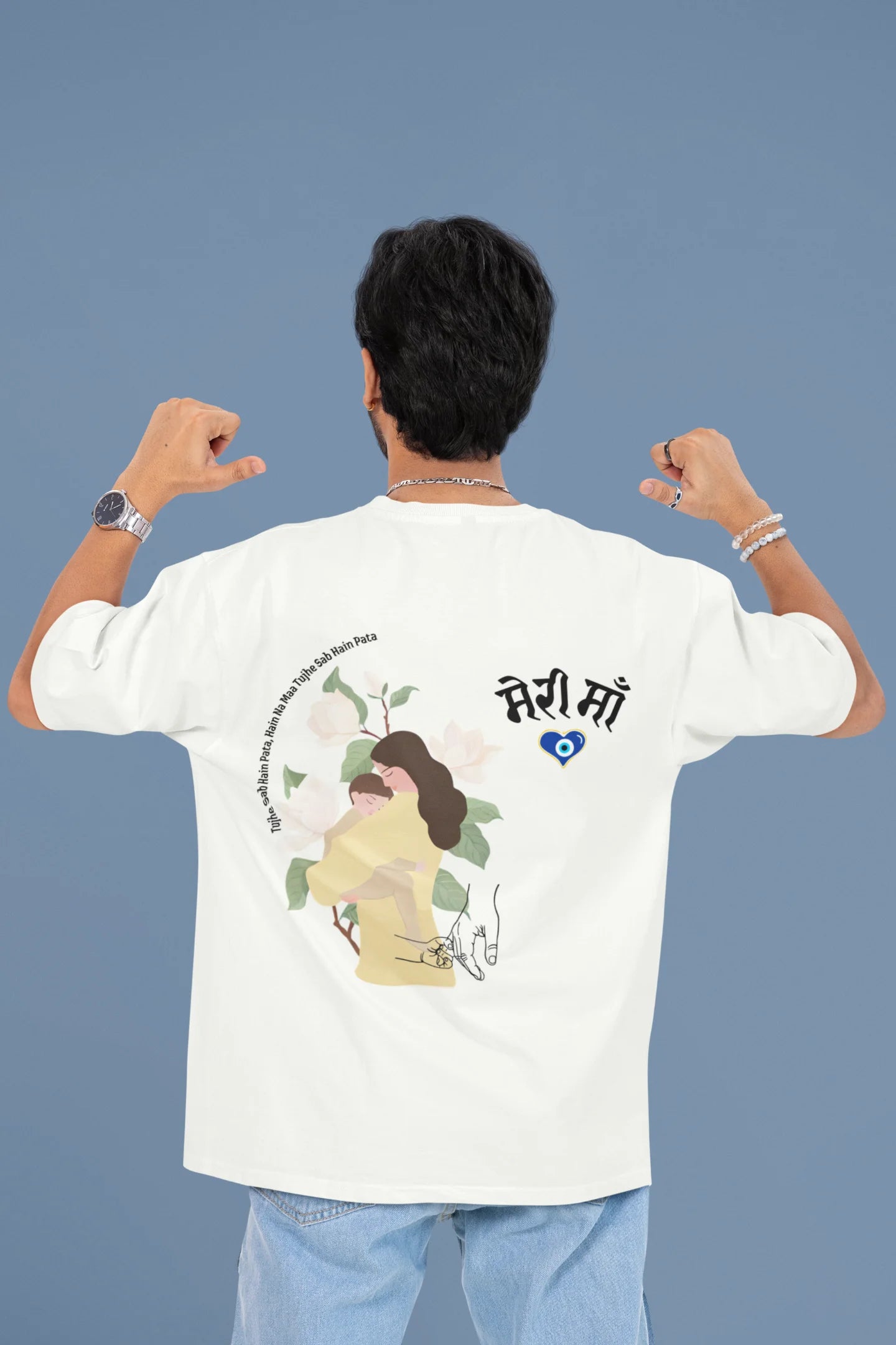 Back view of a male model wearing an off-white oversized t-shirt featuring a design depicting a mother tenderly holding a baby