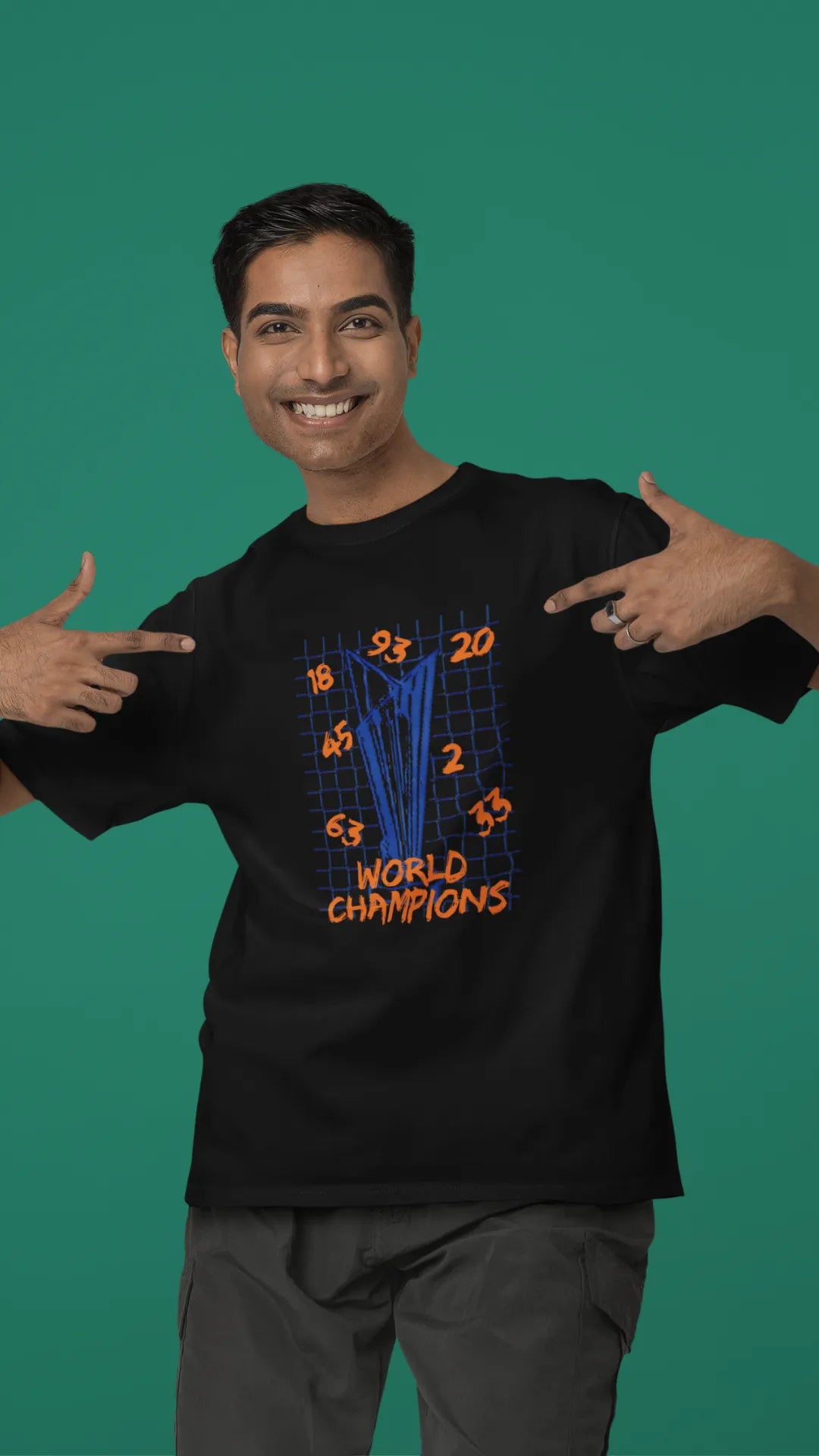 Fourth front image of male model wearing a black oversized t-shirt featuring the World Cup 2024 trophy with the text "World Champions" underneath. Ideal for Indian cricket fans celebrating their team's victory.