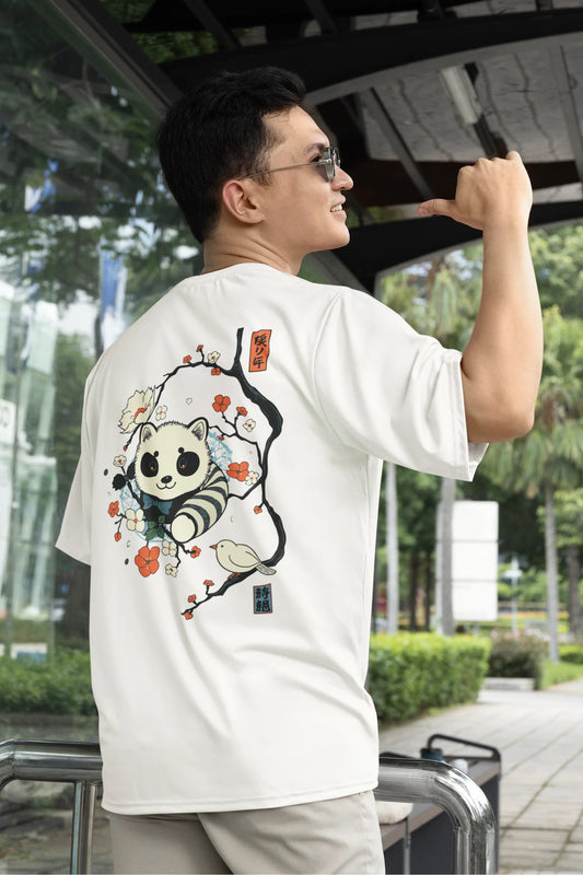 Back view of a male model wearing a off white oversized tee with a panda fox surrounded by bamboo.