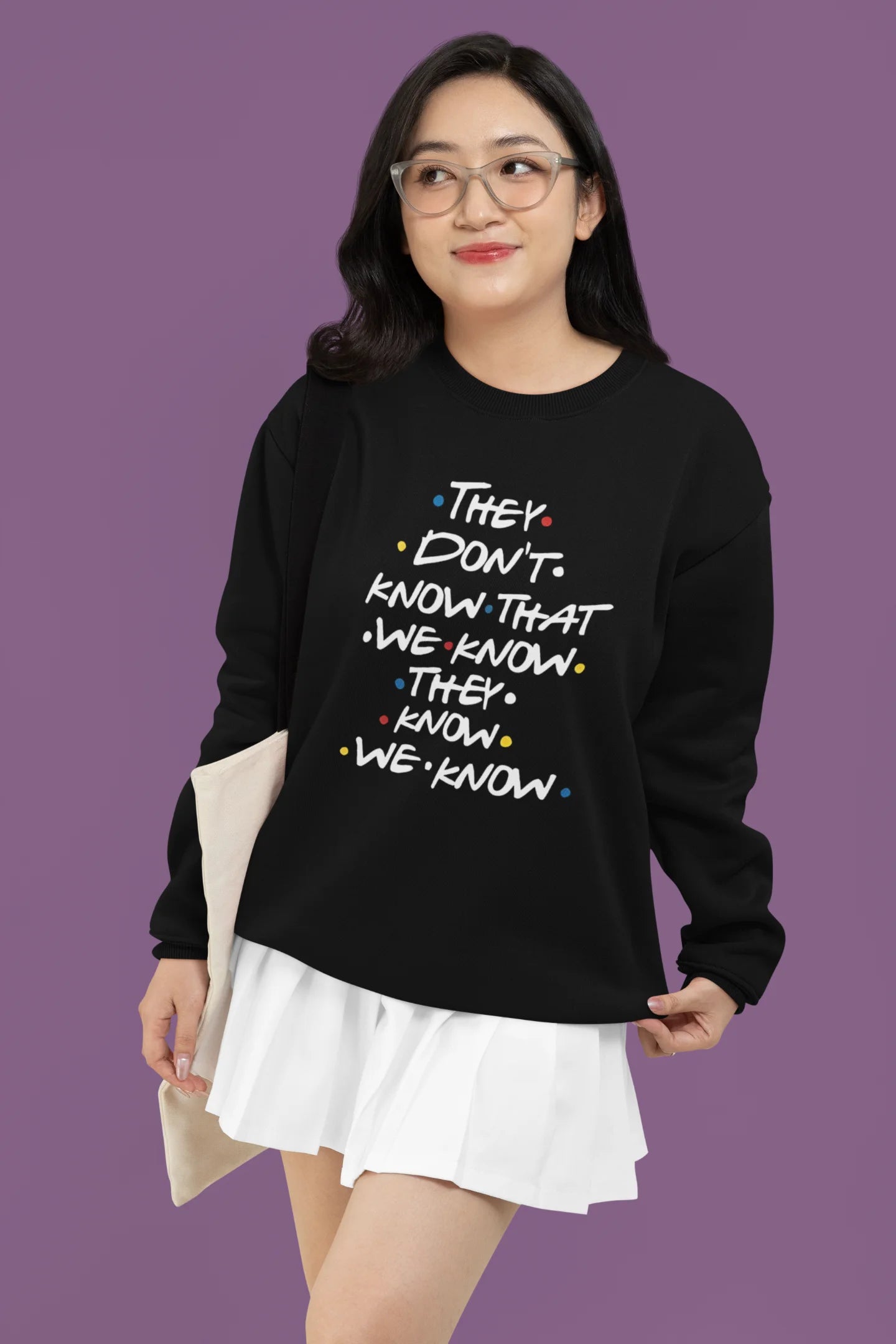 Third image of female model wearing black sweatshirt with F.R.I.E.N.D.S series inspired designs, embodying Phoebe's unique humor with the quote 'They Know We Know'