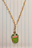 First view of a gold chain necklace featuring a small pendant of a frog themed boba cup.