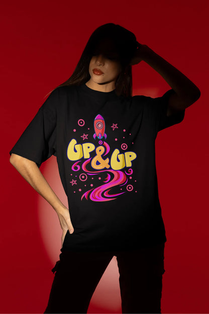 Third front view of a female model wearing an black oversized t-shirt with a rocket ship design and the text "Up & Up".