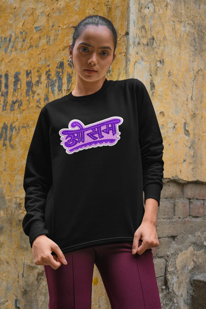 3rd front view of a female model wearing a black colored oversized graphic t-shirt featuring the word "awesome" in a Hindi script.