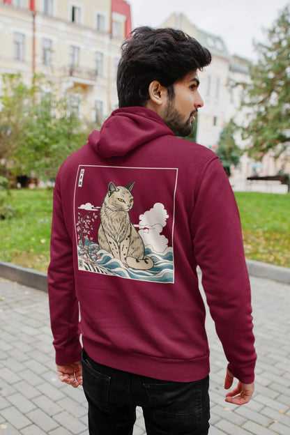 Back view of a male model wearing a maroon hoodie with a design of a wildcat sitting on ocean waves.