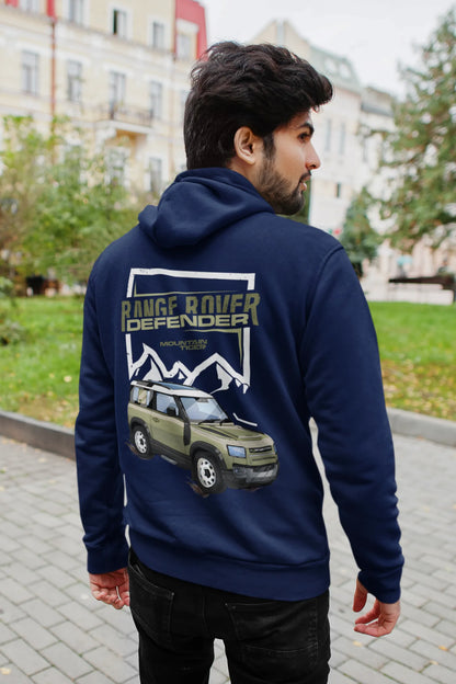 Back view of a male model wearing a navy hoodie featuring a Range Rover Defender design, exuding power and ruggedness.