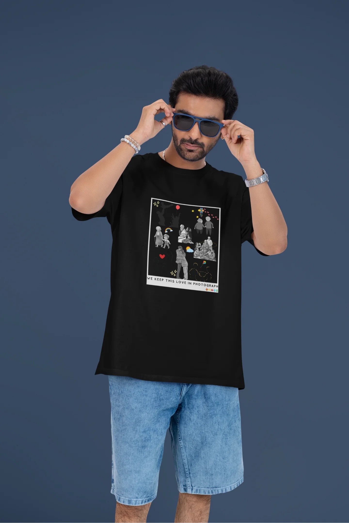 3rd front view of a male model wearing a black oversized t-shirt featuring a design that represents cherished memories, inspired by Ed Sheeran's "Photograph."