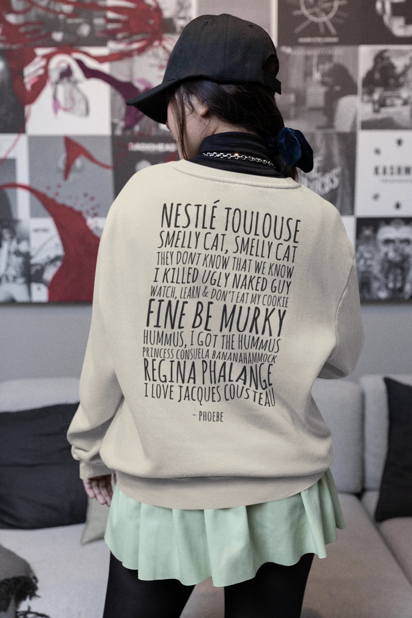 Back view of female model wearing a off-cream F.R.I.E.N.D.S. sweatshirt featuring a fun design inspired by Phoebe Buffay and her iconic quotes.