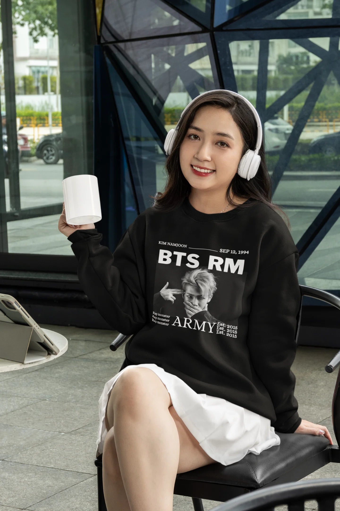 Third front view of female model wearing a black sweatshirt featuring a design representing all seven members of BTS. Ideal for BTS fans (ARMY) who want to show their love for the entire group.
