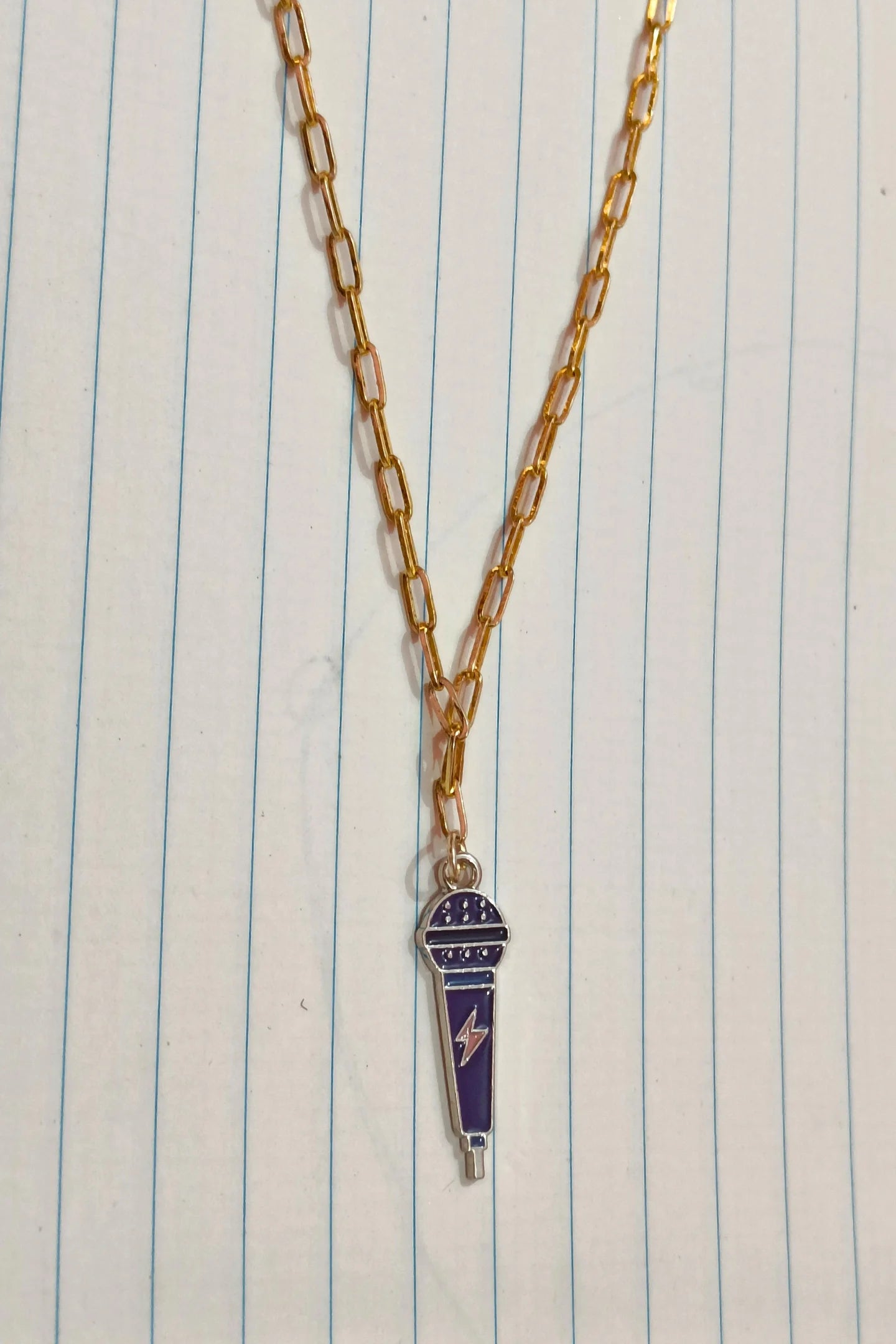 2nd view of a gold chain necklace with a small pendant shaped like a K-Pop microphone.