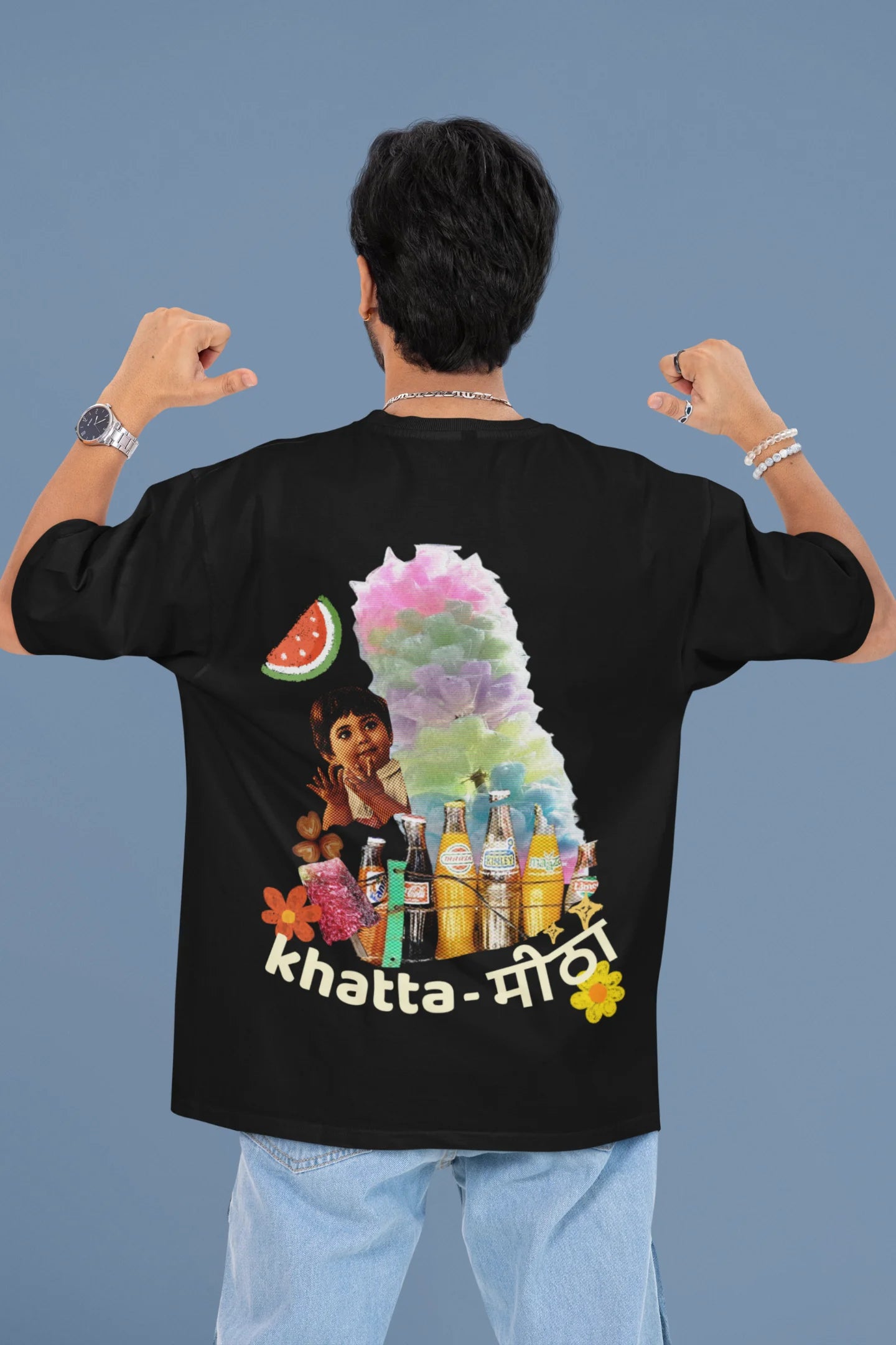 Back view of a male model wearing a black oversized t-shirt with a design representing "Bachpan" (childhood) and the concept of "Khatta Mitha" (sweet and sour).