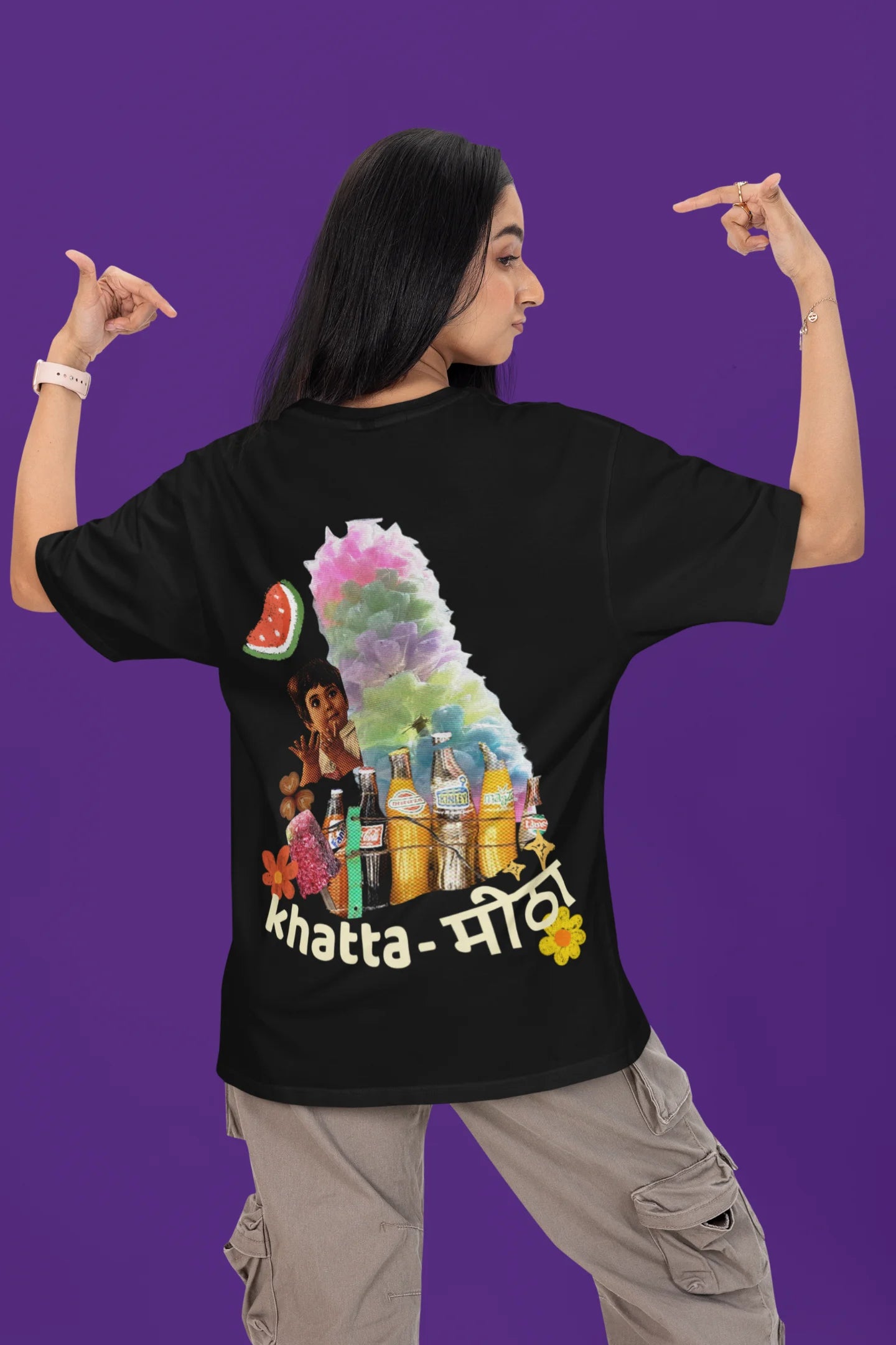 Back view of a female model wearing a black oversized t-shirt with a design representing "Bachpan" (childhood) and the concept of "Khatta Mitha" (sweet and sour).
