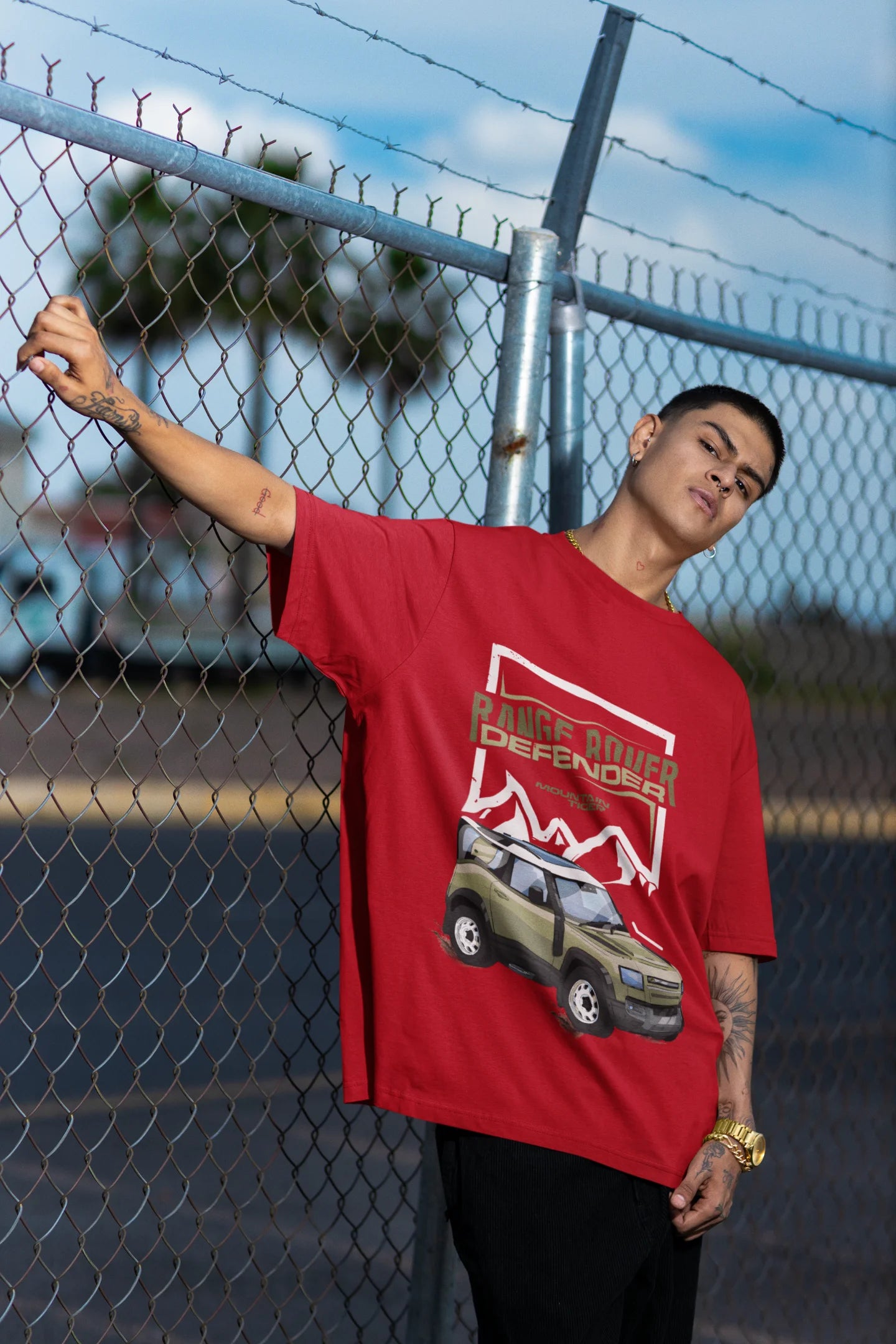 First front view of a male model red wearing a oversized t-shirt featuring a design of a Range Rover.