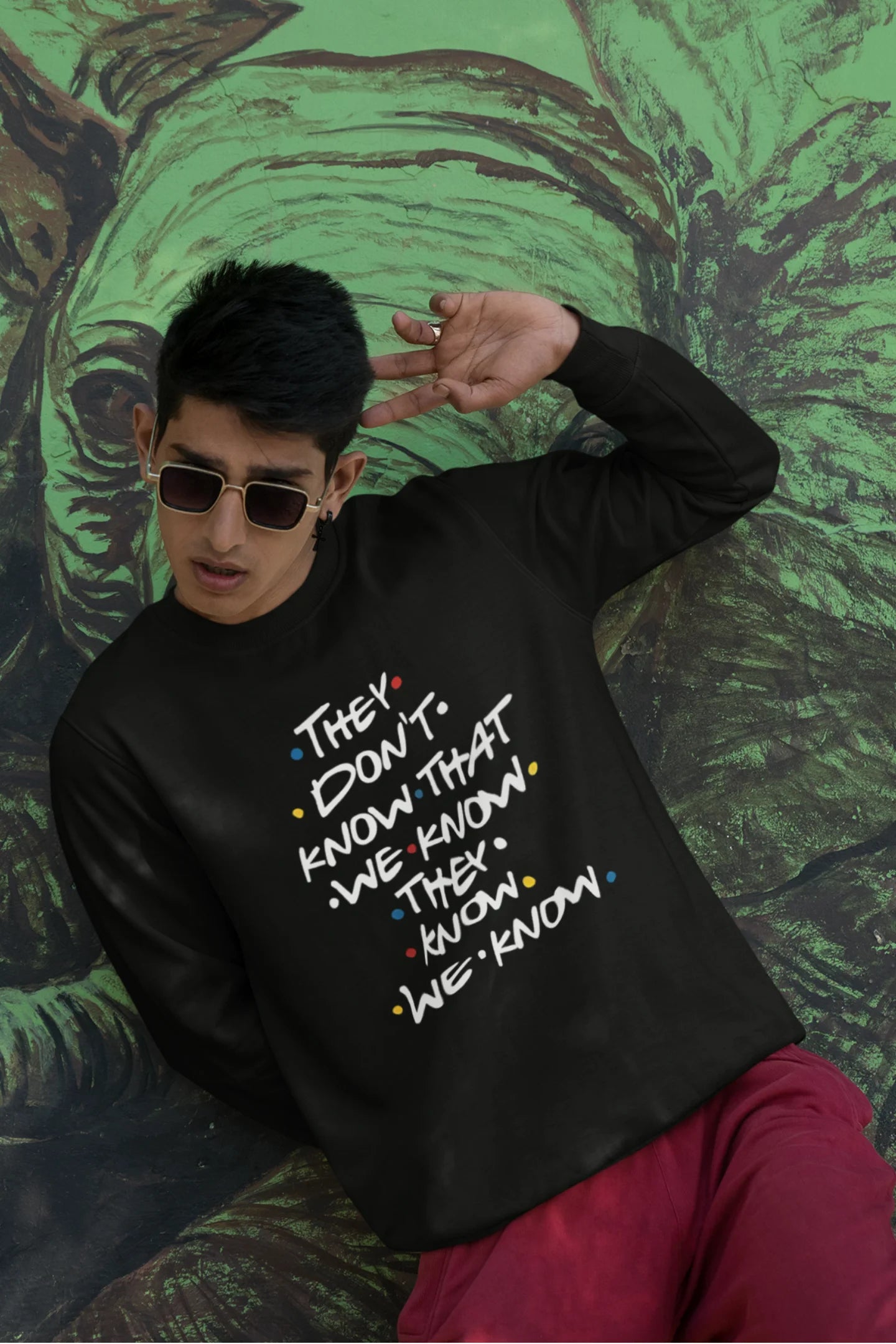 Second image of female model wearing black sweatshirt with F.R.I.E.N.D.S series inspired designs, embodying Phoebe's unique humor with the quote 'They Know We Know'