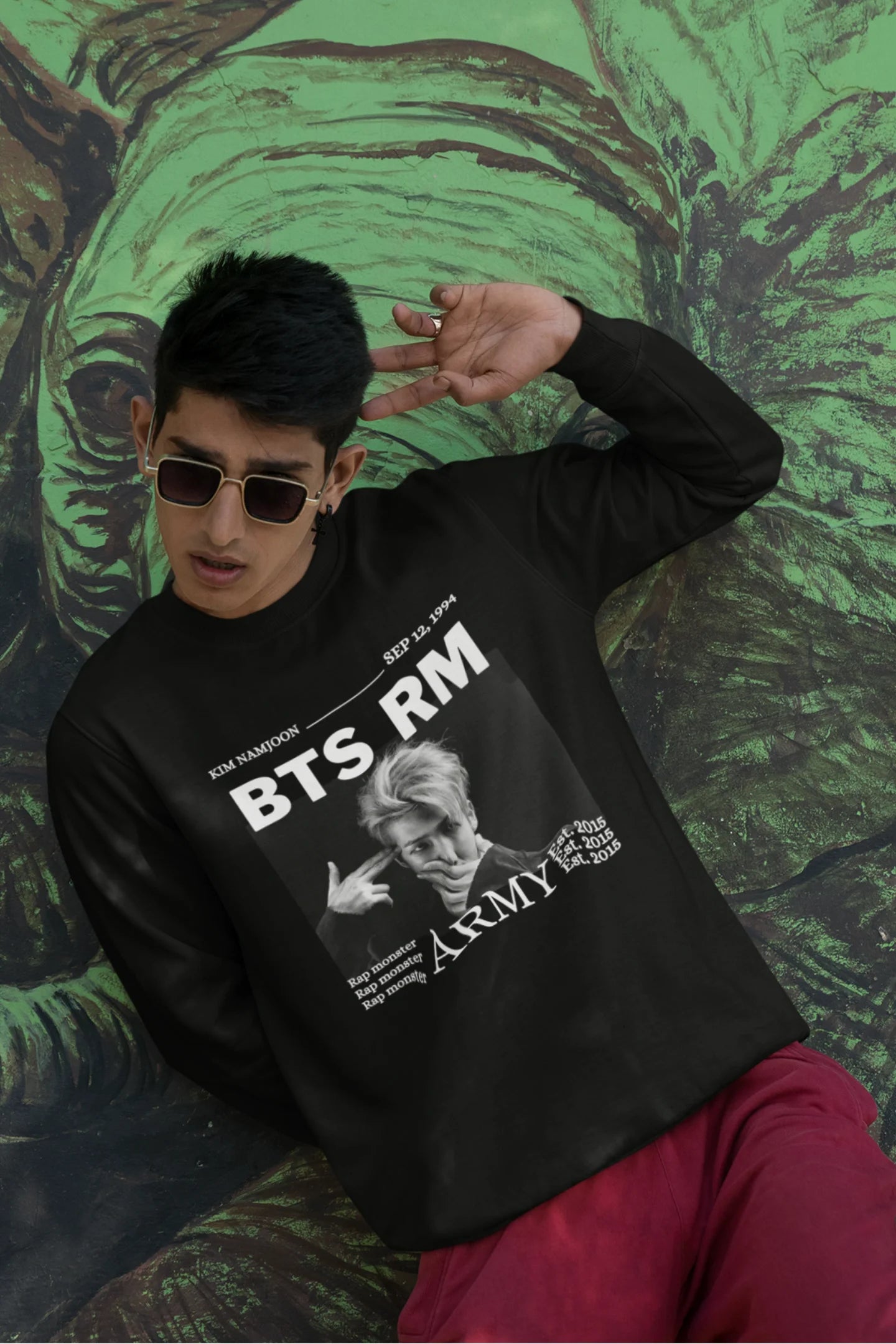 First front view of male model wearing a black sweatshirt featuring a design representing all seven members of BTS. Ideal for BTS fans (ARMY) who want to show their love for the entire group.
