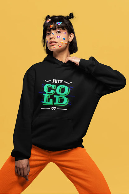 4th front view of a female model wearing an black sweatshirt with the text "Just Cold" printed on it.