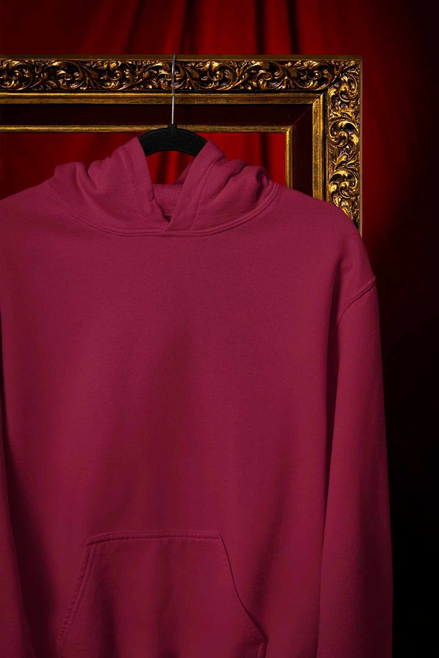 Front view of a maroon hoodie with a design of a wildcat sitting on ocean waves.
