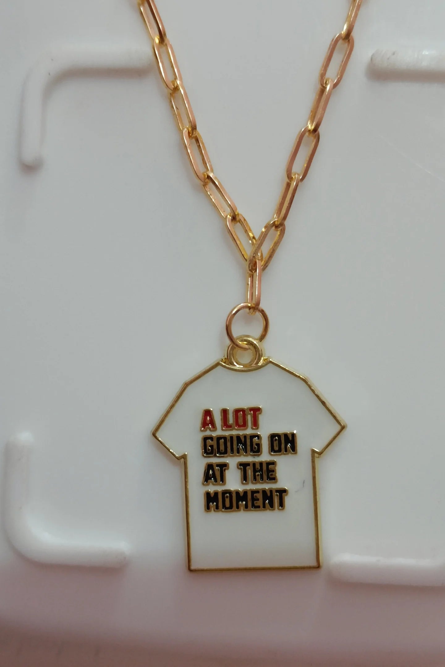 Third image of an anti tarnish gold chain necklace featuring a design inspired by Taylor Swift's "Midnights" album perfect for any swiftie.