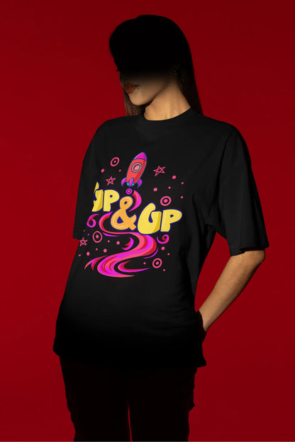 First front view of a female model wearing an black oversized t-shirt with a rocket ship design and the text "Up & Up".