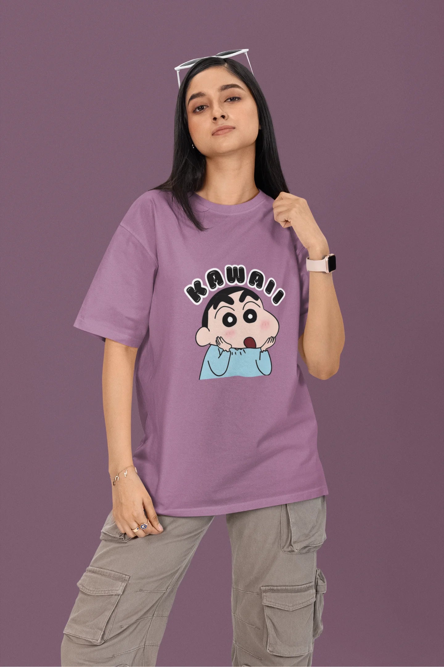 2nd front view of a female model wearin a dirty purple oversized t-shirt featuring Shinchan looking amazed and saying "Kawaii."