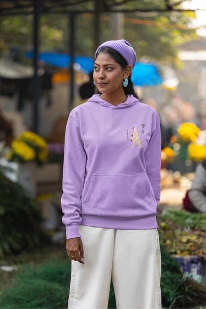 Fifth front view of a female model wearing a lavender hoodie with a design of the three wise monkeys: "See no evil, hear no evil, speak no evil."