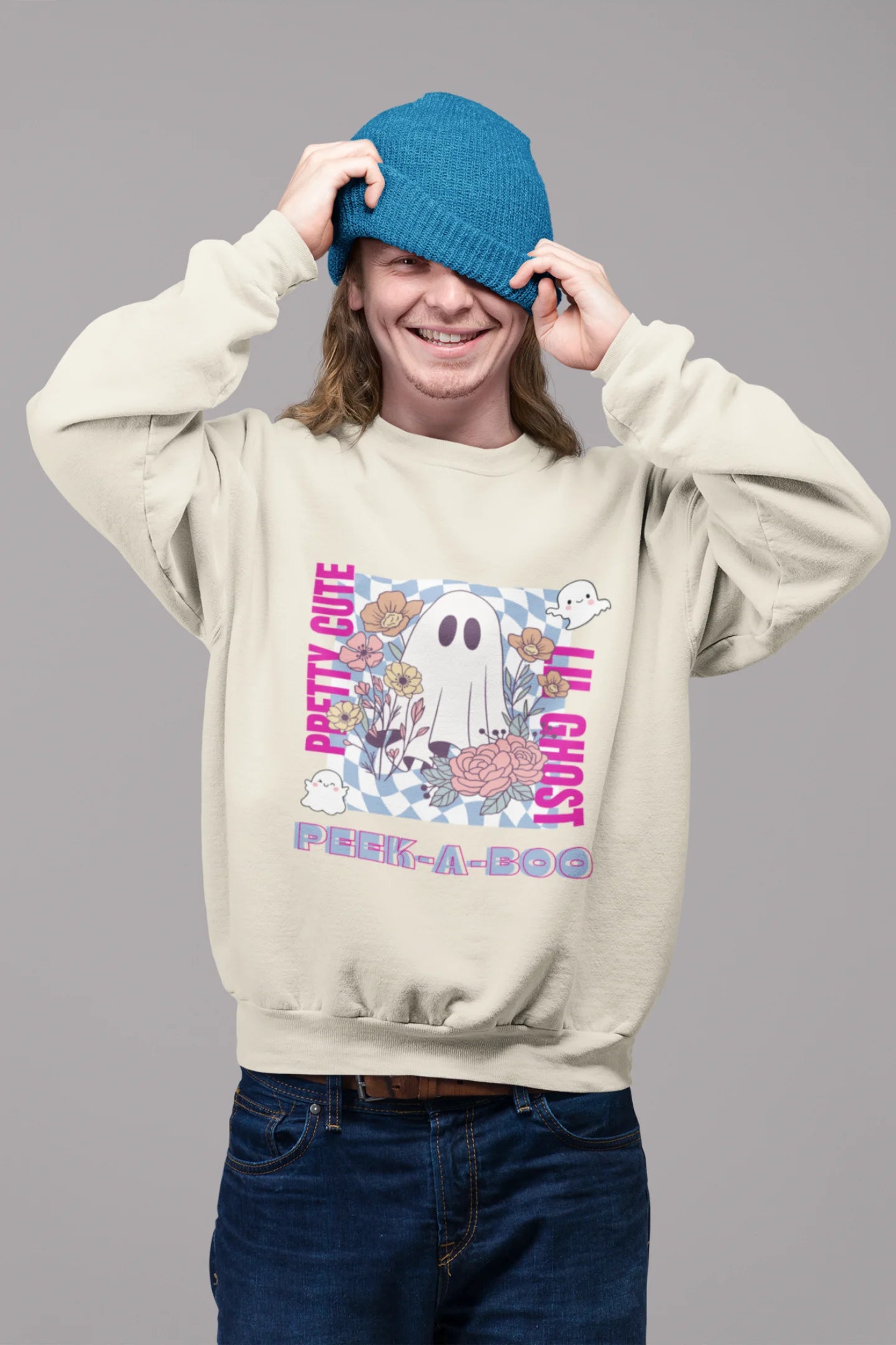 First front view of a male model wearing a trendy cream sweatshirt featuring a cute little ghost surrounded by flowers.