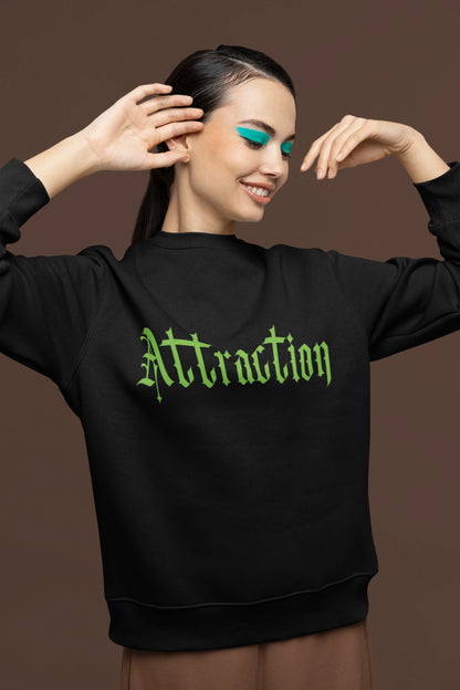 First front view of a female model wearing a black sweatshirt with a brutalist design featuring two statues kissing and the word "Attraction".