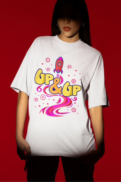 Third front view of a female model wearing an off-white oversized t-shirt with a rocket ship design and the text "Up & Up".