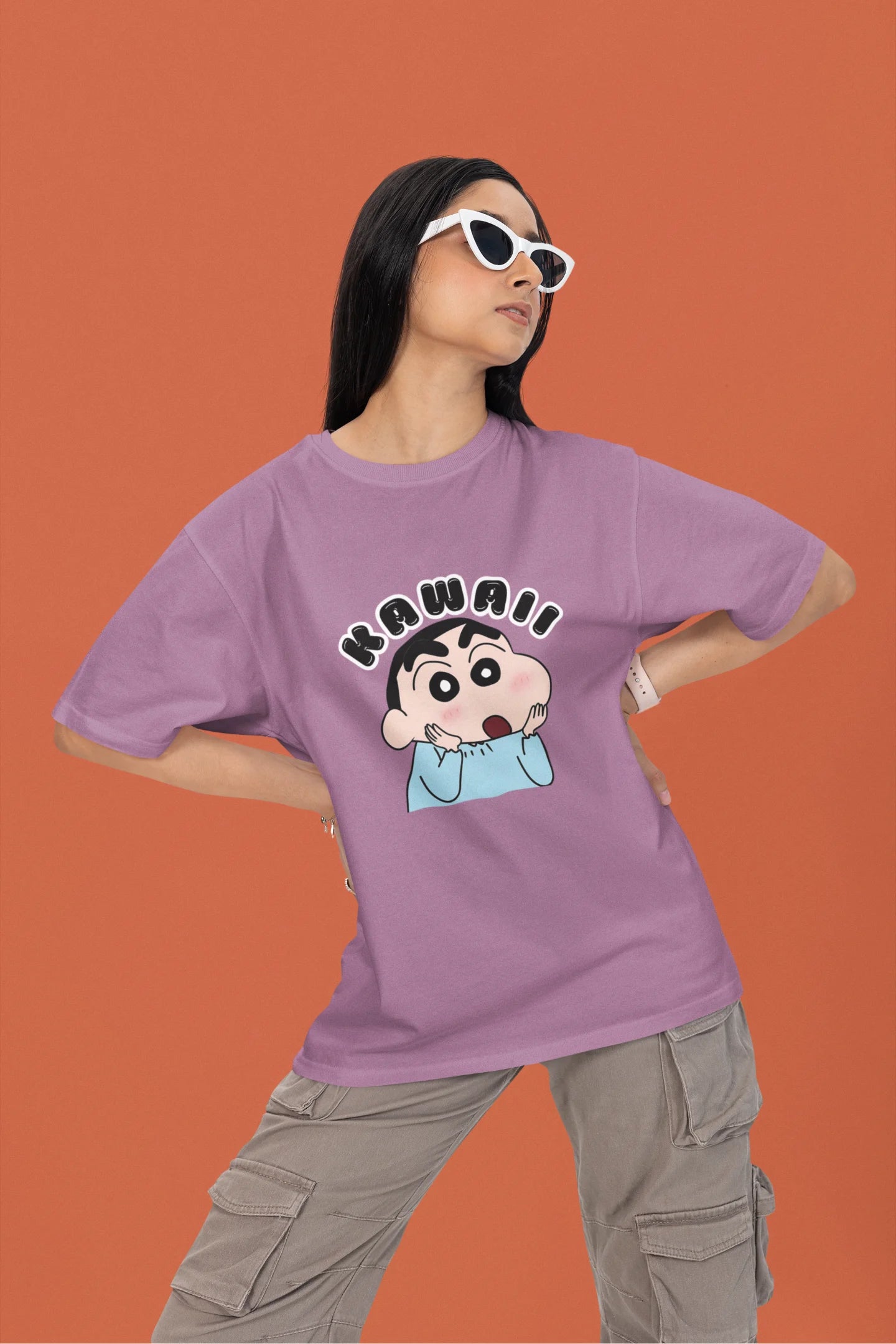 First front view of a female model wearin a dirty purple oversized t-shirt featuring Shinchan looking amazed and saying "Kawaii."