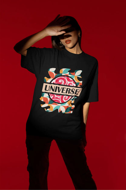 Second front view of a female model wearing an black oversized t-shirt with a cosmic Universe design inspired by Coldplay.