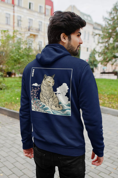 Back view of a male model wearing a navy blue hoodie with a design of a wildcat sitting on ocean waves.